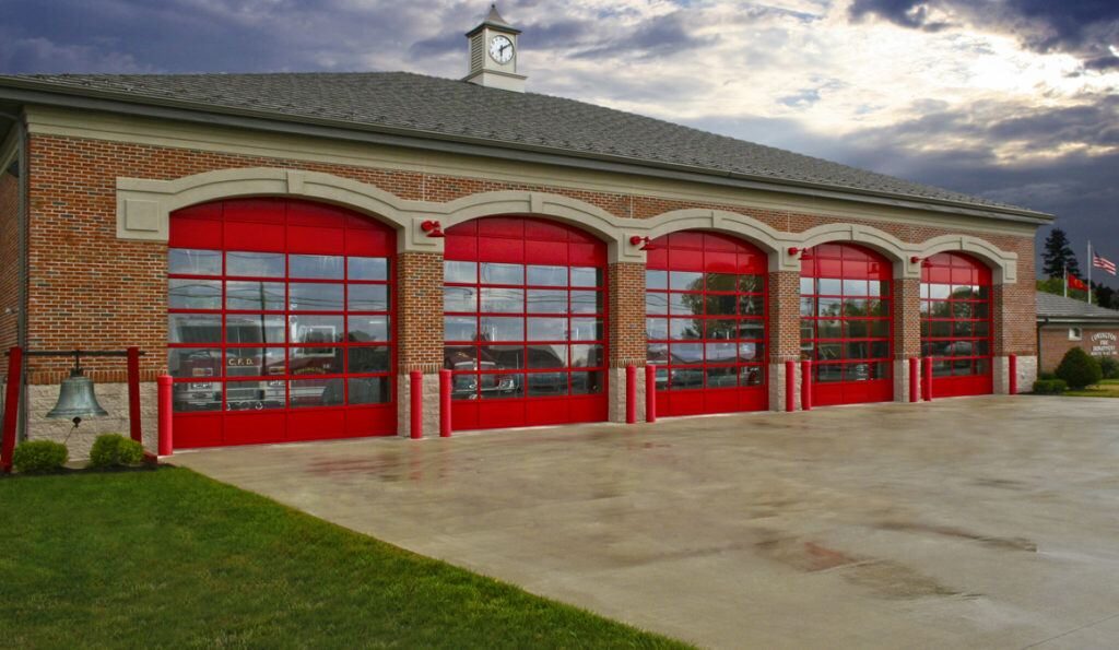 Fire station with four red, glass commercial garage doors - commercial garage door repair in Portland